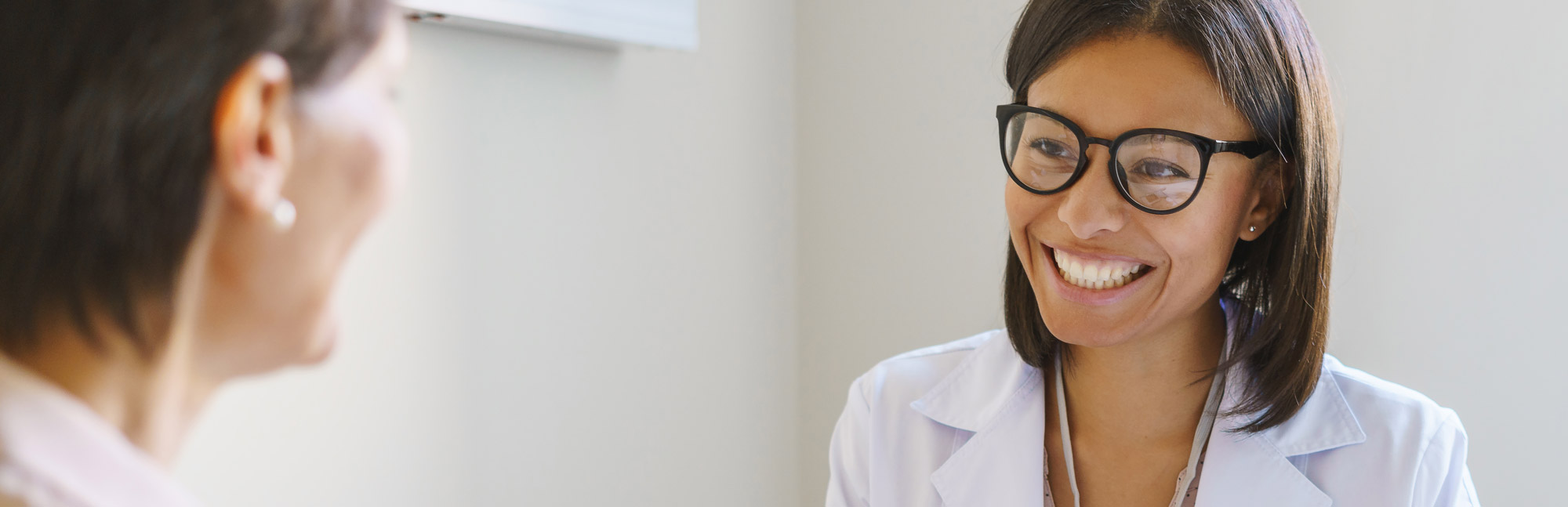 Two nurses smiling at each other